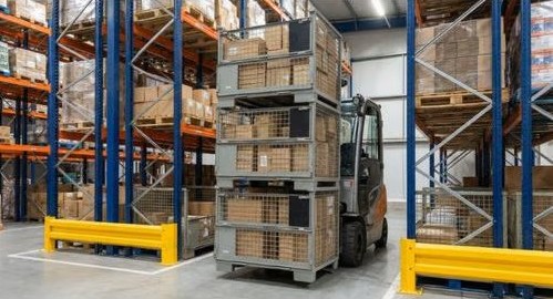 Steel mesh stillages being moved by forklift