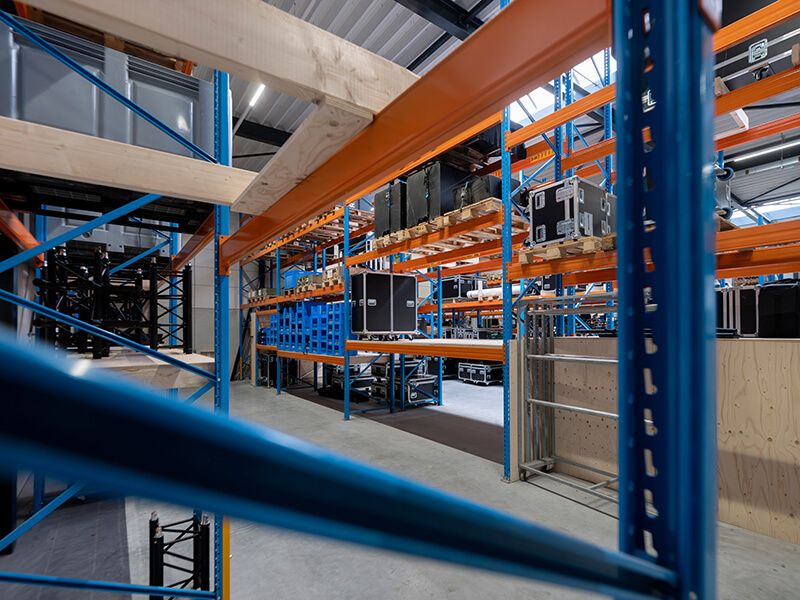 View looking from on one of the racking shelves in a warehouse, beam close up in the foreground